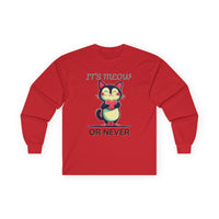 Red long-sleeve Valentine's shirt featuring an adorable cat-themed design. The front showcases a cute black and white cartoon cat with rosy cheeks, holding a red heart and smiling sweetly. Above and below the cat, playful text reads "IT'S MEOW OR NEVER" in a fun, romantic font. This cat lovers' shirt is perfect for Valentine's Day, offering a charming and lighthearted way to celebrate love and affection with a feline twist.