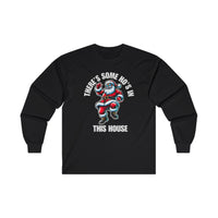 A black long sleeve t-shirt featuring a cool Santa Claus wearing sunglasses and dancing. Above him, the bold white text reads "THERE'S SOME HO'S IN," and below, "THIS HOUSE" is written in large white capital letters.