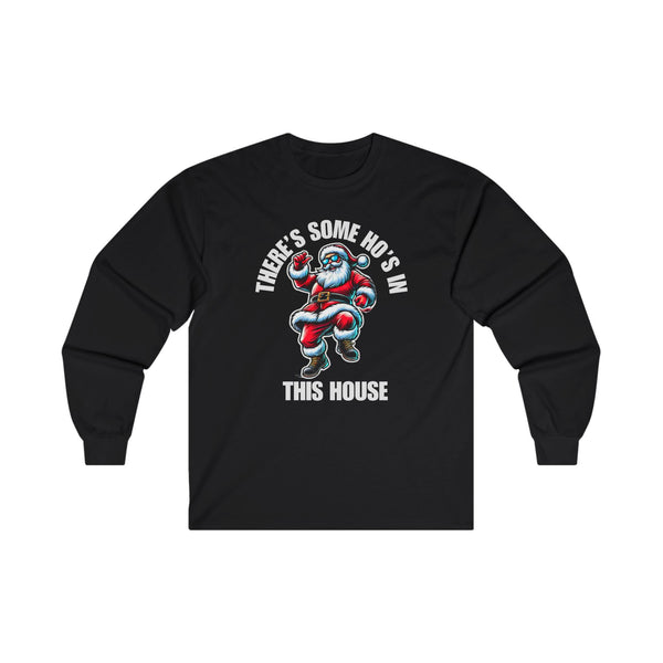 A black long sleeve t-shirt featuring a cool Santa Claus wearing sunglasses and dancing. Above him, the bold white text reads "THERE'S SOME HO'S IN," and below, "THIS HOUSE" is written in large white capital letters.