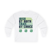 White long-sleeve t-shirt with bold green and navy text reading 'Irish By Birth Craic By Choice' over stripes, celebrating Irish pride and St. Patrick’s Day. Perfect for festive apparel, parades, and parties. Embrace the spirit of craic and Irish heritage!